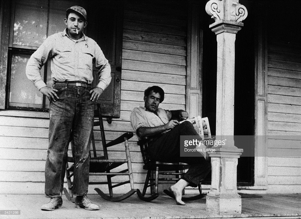 3431266-july-1936-a-father-and-son-on-the-porch-of-a-gettyimages-1.jpg