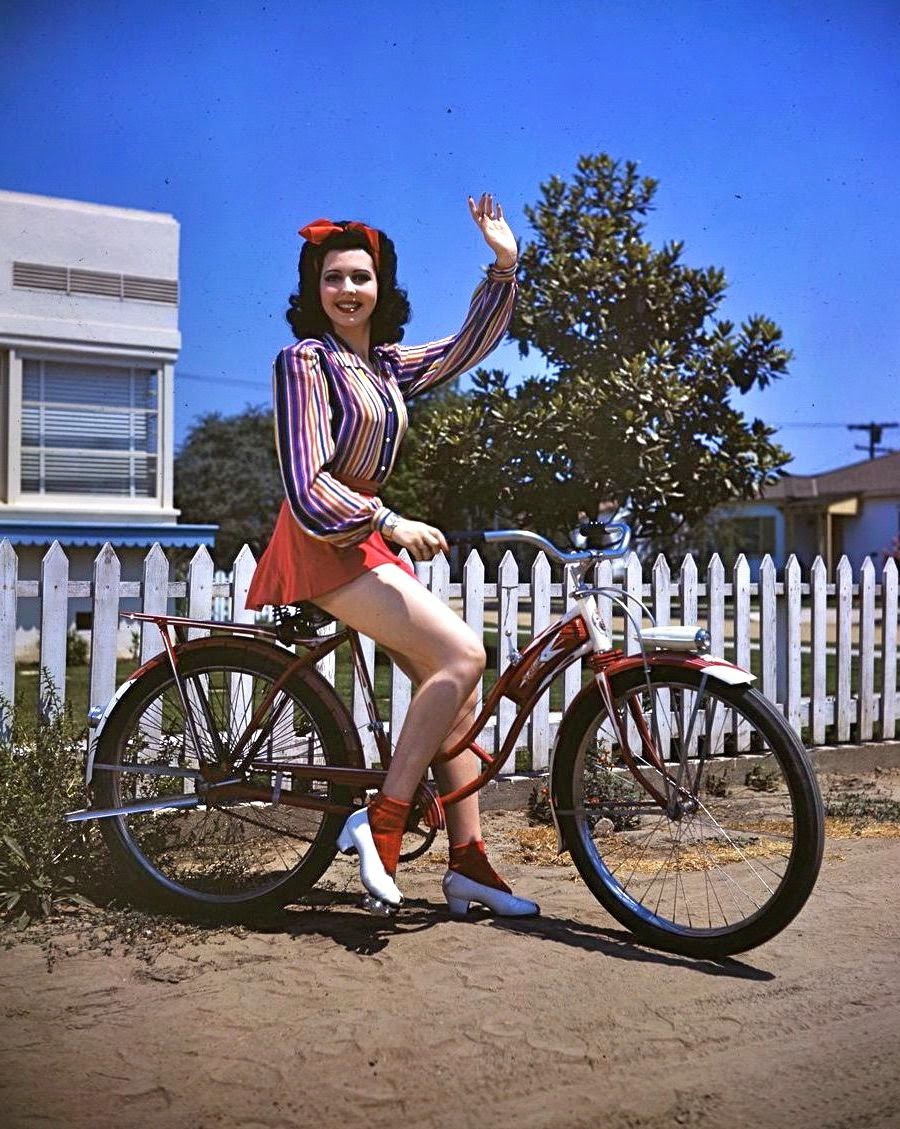 Ann Miller waves a bike. 1946.jpg